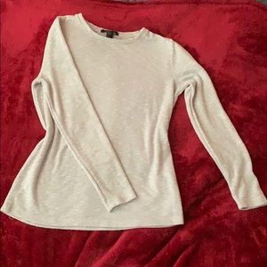 A beige long sleeve sweater